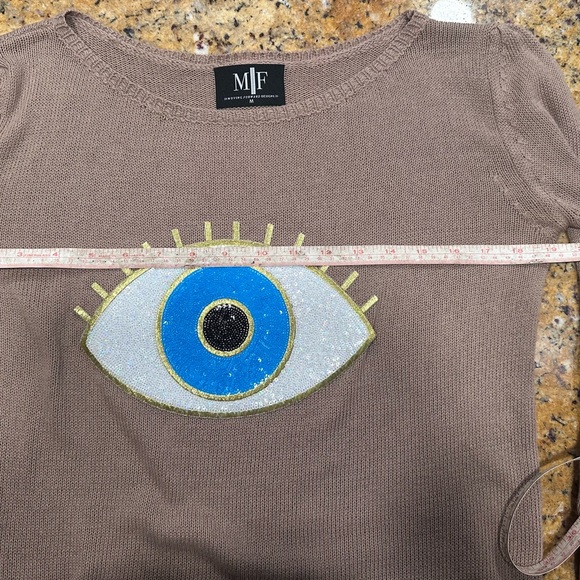 Moving Forward Tan Sweater with Blue and Gold Evil Eye Design - Picture 7 of 8